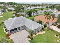 Stunning home showcasing a beautiful gray roof, landscaped yard and charming curb appeal at 2306 Emerald Lake Dr, Sun City Center, FL 33573