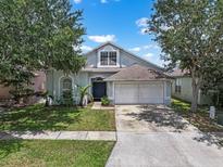 Charming single-Gathering home featuring a two-car garage, well-maintained lawn, and mature trees at 509 Delwood Breck St, Ruskin, FL 33570