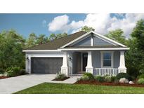 Charming single-story home showcasing a well-manicured lawn and attached two-car garage at 720 Sky Shade Dr, Apollo Beach, FL 33572
