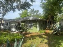 Charming exterior of the single-story home with lots of large trees and greenery at 159 6Th Nw St, Largo, FL 33770