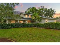 Charming home featuring a well-manicured lawn, lush landscaping, and a welcoming front entrance, perfect curb appeal at 2272 Adam Ct, Palm Harbor, FL 34683