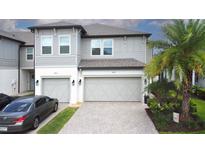Charming townhome with a two car garage, paved driveway, and lovely landscaping at 2435 Foggy Creek Cir, Clearwater, FL 33764