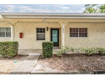 Charming condo with stucco exterior, landscaped front, and clearly marked address at 2465 Northside Dr # 605, Clearwater, FL 33761