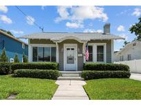 Charming single-story home featuring manicured landscaping, light gray paint, trimmed bushes and a classic design at 2811 W Sitios St, Tampa, FL 33629