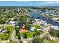 Waterfront property with lush landscaping, private dock, and access to beautiful waterways at 301 Carlyle Blvd, Ruskin, FL 33570