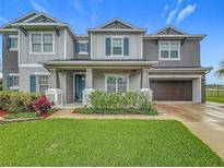Charming two-story home with landscaped yard, blue shutters, and two-car garage in a desirable neighborhood at 33668 Willow Point Ct, Wesley Chapel, FL 33545
