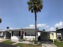 Charming single-story home featuring a carport and a lush green lawn at 4851 W Gandy Blvd # B2L10, Tampa, FL 33611