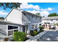 Charming townhome featuring well-maintained landscaping and a paved walkway leading to the front entrance at 500 New York Ave # 22, Dunedin, FL 34698