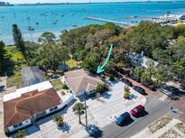 Beautiful waterfront home with lush landscaping and scenic views of the bay with boats and a pier at 5240 31St S Ave, Gulfport, FL 33707