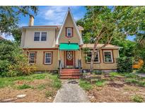 Charming, two-story home showcasing unique architectural details and a well-maintained front yard at 535 22Nd N Ave, St Petersburg, FL 33704