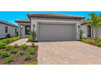 Charming single Gathering home featuring a two-car garage and beautifully landscaped front yard at 6133 Wire Grass Ct, Nokomis, FL 34275