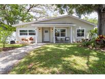 Charming single-story home with a well-manicured lawn and inviting front porch at 615 6Th N Ave, Safety Harbor, FL 34695