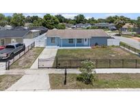 Charming single-story home featuring a well-maintained yard, fenced perimeter, and private driveway at 6417 Willow Wood Ln, Tampa, FL 33634