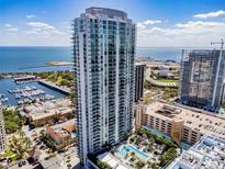 Stunning aerial view of a modern high-rise condo building overlooking the bay and downtown cityscape at 100 1St N Ave # 2304, St Petersburg, FL 33701