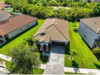 An aerial view shows the house and property with a view of green space in the neighborhood at 13113 Green Violet Dr, Riverview, FL 33579