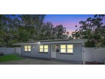 Charming single-story home with a well-maintained gray exterior and mature trees at 2718 Boca Ciega N Dr, St Petersburg, FL 33710
