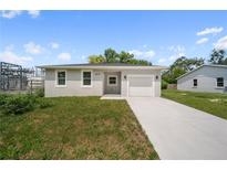 Charming single-story home features a well-manicured lawn and a driveway leading to an attached one-car garage at 2810 N 75Th St, Tampa, FL 33619