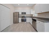 Bright kitchen features stainless steel appliances, granite countertops, and crisp white cabinetry at 2810 N 75Th St, Tampa, FL 33619