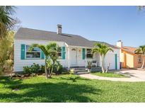 Charming single-story home with a well-manicured lawn, decorative shutters, and a cozy front porch at 434 77Th Ave, St Pete Beach, FL 33706