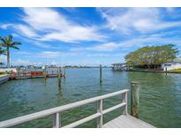 Beautiful waterfront view from the pier with palm trees and blue skies at 4545 Clearwater Harbor N Dr, Largo, FL 33770