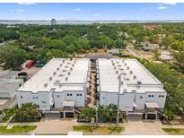 An eye-level aerial view of the community highlighting manicured landscaping and nearby trees at 5008 S Macdill Ave # 16, Tampa, FL 33611