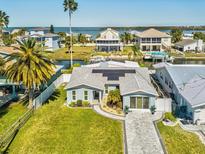 Beautiful single-Gathering home with solar panels, paved driveway, manicured lawn, and nearby waterfront views at 6531 Seaview Blvd, Hudson, FL 34667