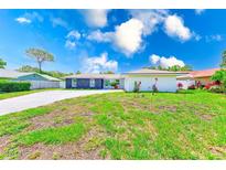 Charming home with a well-manicured front yard and a spacious driveway, perfect for Gathering living at 9027 Merrimoor Blvd, Seminole, FL 33777