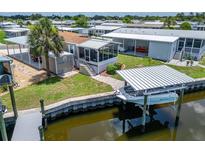 Waterfront home featuring screened lanai, boat dock, and lift at 108 W Saint Annes Cir, Apollo Beach, FL 33572