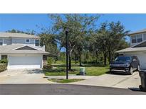 Well-maintained townhome with a two-car garage and a neatly landscaped front yard at 19251 Stone Hedge Dr, Tampa, FL 33647