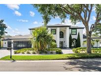 Stunning two-story home boasts a modern design, lush landscaping, and a brick driveway at 2819 Safe Harbor Dr, Tampa, FL 33618