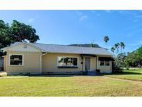 Charming single-story home featuring a well-manicured lawn and a welcoming front entrance at 3415 Overlook Ne Dr, St Petersburg, FL 33703