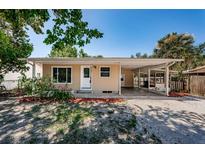 Charming single-story home with a covered carport and well-maintained front yard at 8184 49Th N Ave, St Petersburg, FL 33709