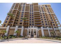 Stunning multi-story condominium building exterior with a manicured entrance and landscaping at 11 Baymont St # 505, Clearwater Beach, FL 33767