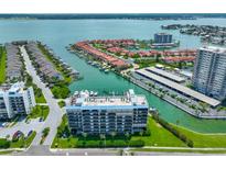 Beautiful aerial view of waterfront condos with boat docks and lush landscaping on the inter-coastal waterway at 1591 Gulf Blvd # 304S, Clearwater Beach, FL 33767