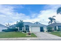Charming single-story home with lush lawn and well-maintained landscaping at 1607 Alexander Crossing Way, Sun City Center, FL 33573