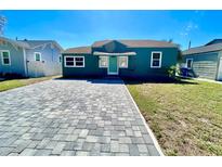 Charming home with a light-teal front door and a newly paved driveway, offering curb appeal at 3110 10Th N Ave, St Petersburg, FL 33713