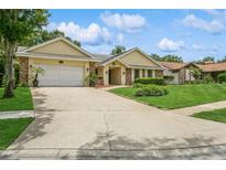 Charming single story home with a two car garage, manicured lawn, and beautiful landscaping at 3262 Westcott Ct, Palm Harbor, FL 34684