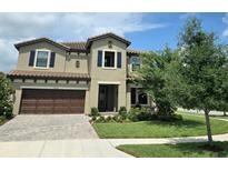 Charming two-story home with a well-manicured lawn and beautiful landscaping at 3984 Maurice Ave, Odessa, FL 33556