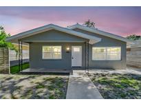 Charming home featuring updated gray paint, new windows, and inviting curb appeal with sidewalk leading to the front door at 483 32Nd N Ave, St Petersburg, FL 33704