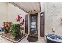 Inviting front door with decorative shutters and manicured landscaping welcomes you home at 501 E Bay Dr # 802, Largo, FL 33770