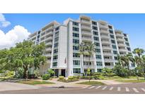 Stunning exterior view of Harbour Hill, featuring balconies, lush landscaping, and direct street access at 700 Beach Ne Dr # 606, St Petersburg, FL 33701