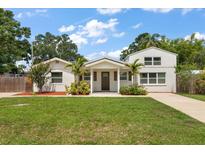 Charming home featuring a well-maintained lawn, mature trees, and a welcoming front entrance at 2306 Cheryl Rd, Largo, FL 33771