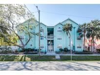 Charming turquoise condo building with lush landscaping and a welcoming entrance at 3002 W Cleveland St # B9, Tampa, FL 33609