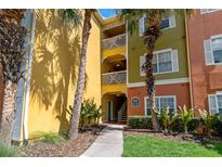 Condo building with multiple levels featuring colorful facades, tropical landscaping, and walkways at 4207 S Dale Mabry Hwy # 8304, Tampa, FL 33611