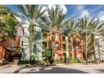 Beautiful building facade with palm trees, colorful paint, multiple windows, and balcony views at 504 S Armenia Ave # 1329B, Tampa, FL 33609