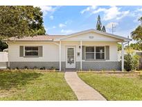Charming one-story home featuring a well-manicured lawn, walkway, and decorative shutters and an inviting front entrance at 5221 4Th N Ave, St Petersburg, FL 33710