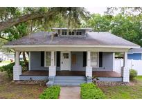 Charming single-story home featuring a welcoming front porch and beautiful, mature landscaping at 606 N Merrin St, Plant City, FL 33563
