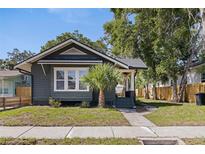 Charming bungalow-style home with well-maintained lawn, lush trees, and welcoming front porch at 1225 22Nd S Ave, St Petersburg, FL 33705