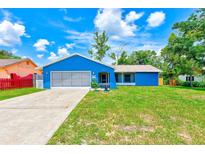 Charming single-story home with a well-manicured lawn and attached garage at 2063 De Carlo Ave, Spring Hill, FL 34608