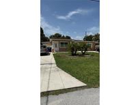 Charming single-story home with well-maintained lawn and landscaping at 2120 W Virginia Ave, Tampa, FL 33607